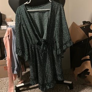 Green and white polka dot romper with a cut out in front!